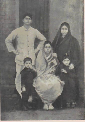 Group photograph dated 1912 showing six people of different ages posed before a doorway.