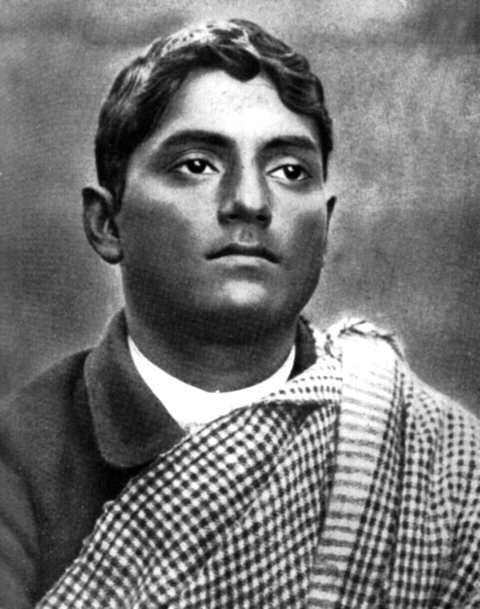 Portrait of Jatindranath Mukherjee, head and shoulders, wearing a checked shawl draped over one shoulder and looking directly at the camera.