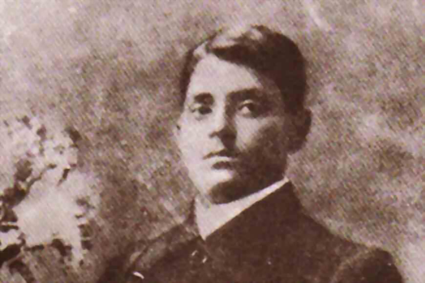 Sepia photograph of a young Jatindranath Mukherjee in a dark jacket, seen from the shoulders up.